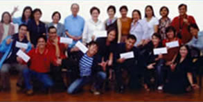 Japan contest participants wave their cash reward envelopes together with official.