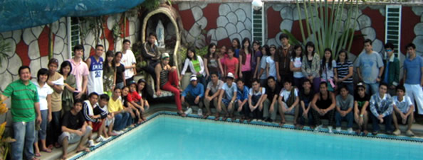 Students pose behind the pool at Golden View Private Resort.
