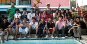 Third year students pose behind the pool at Golden View Private Resort.