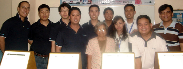 Jaycees members pose behind the animation light boxes they donated to MCCID College.