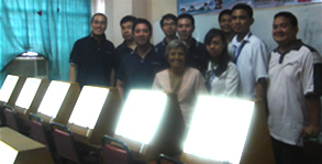 Jaycees members pose behind the animation light boxes they donated to MCCID College.