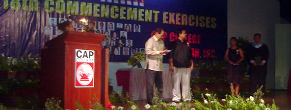 Sir Ervin on stage receiving the plaque of recognition