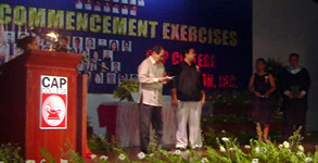 Sir Ervin on stage receiving the plaque of recognition