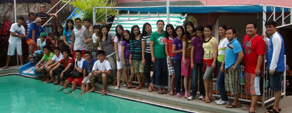 Students pose behind the pool at Golden View III Private Resort.