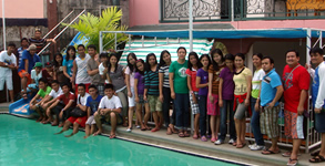 Students pose behind the pool at Golden View III Private Resort.