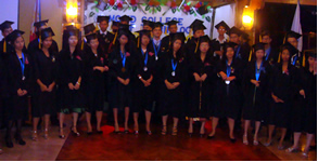 Graduates pose with faculty and administrators.