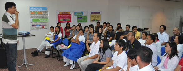 Sir Jojo teaches sign language to Monde Nissin employees.