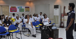 Sir Jerome teaches sign language to Monde Nissin employees.