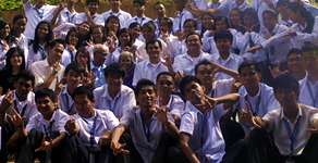 MCCID students pose in front of school building.